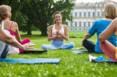 Frauen Schneidersitz auf Wiese - Yoga im Park